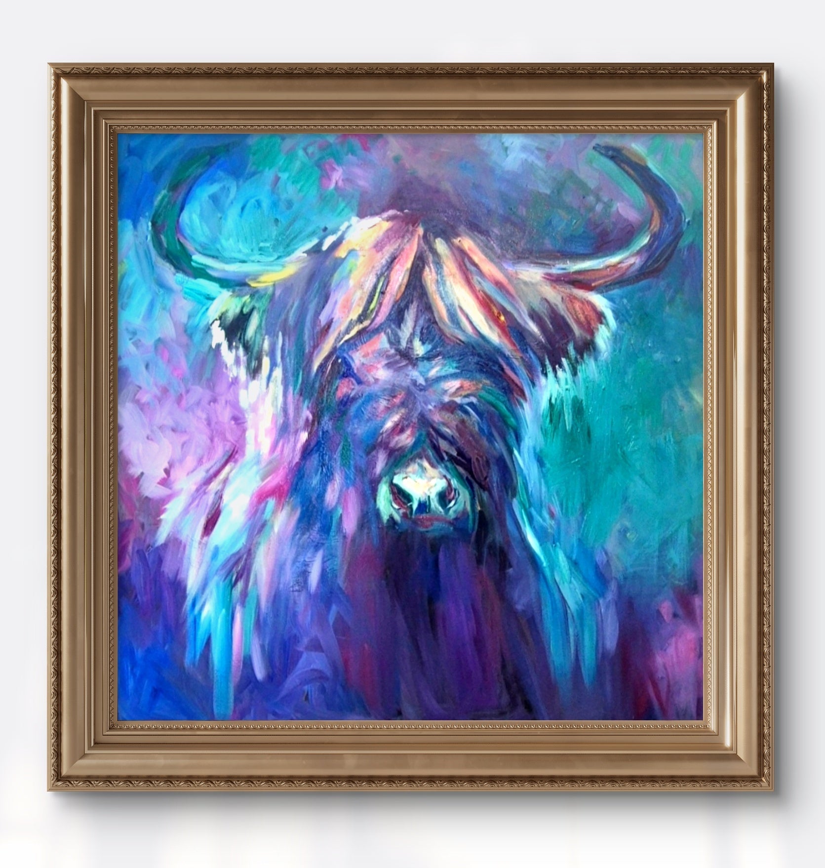 Colorful painting of a bull in a gold frame on a white wall